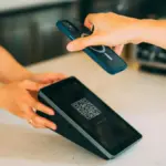 Potret seseorang sedang melakukan pembayaran lewan QR code